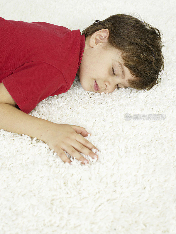 男孩睡在地毯上