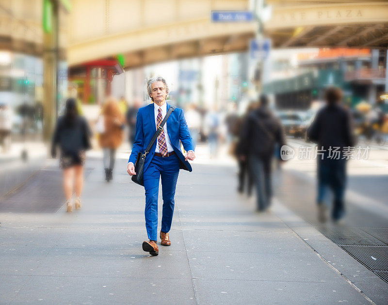 成熟的商人快速行走在纽约的人行道上