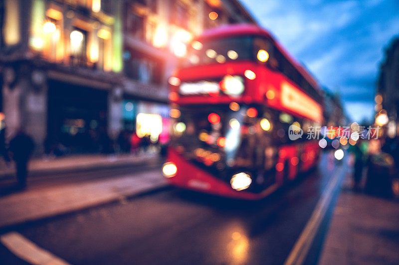 伦敦典型的红色巴士在牛津广场夜间模糊的运动
