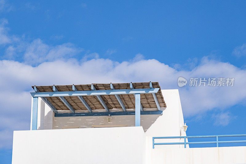 从蓝色天空下看白色建筑立面。