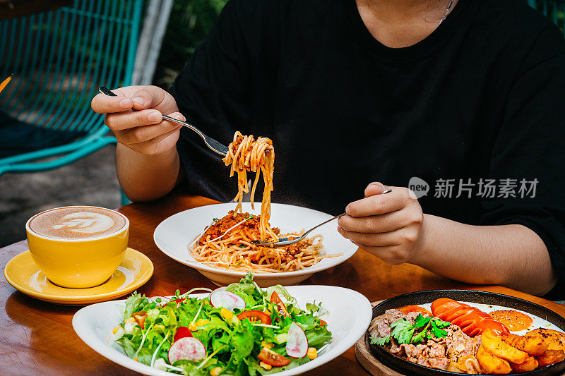 年轻的亚洲女性东亚在花园户外吃早午餐高分辨率股票照片