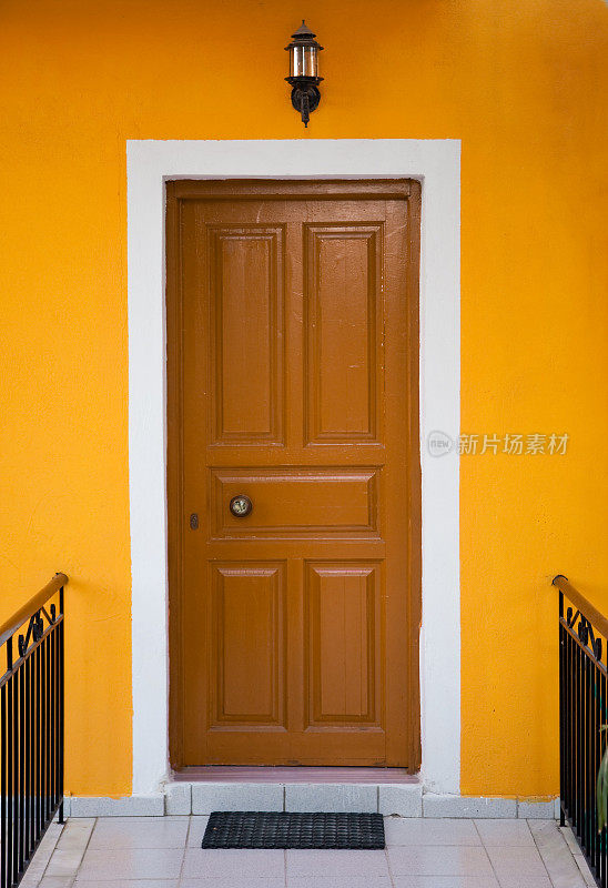 前门是木制的，墙壁是黄色的