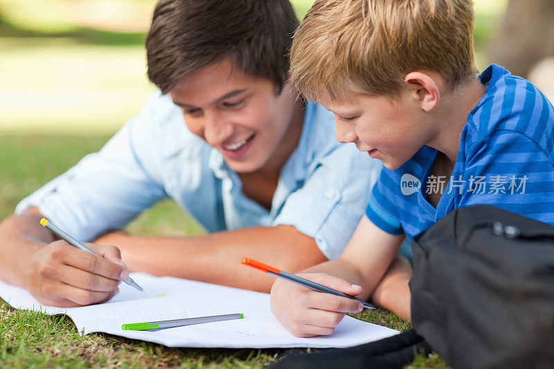 一个男人在帮他儿子做功课