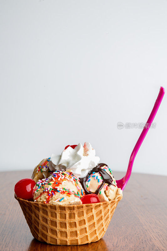 美味的冰淇淋圣代配热软糖，糖屑，樱桃