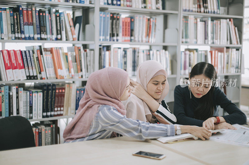 在图书馆学习的亚洲大学生