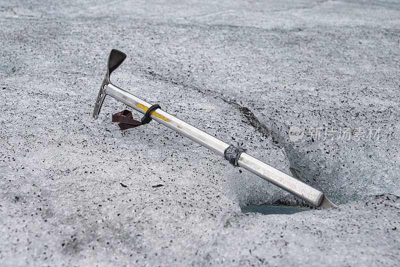 一把铝制的冰斧躺在挪威冰川的冰面上