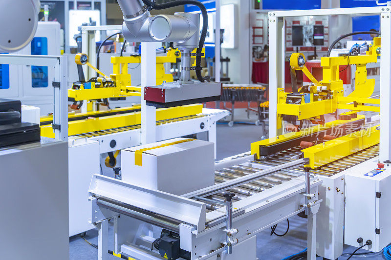 产品包装的纸板箱在制造工厂自动包装机的传送带上移动