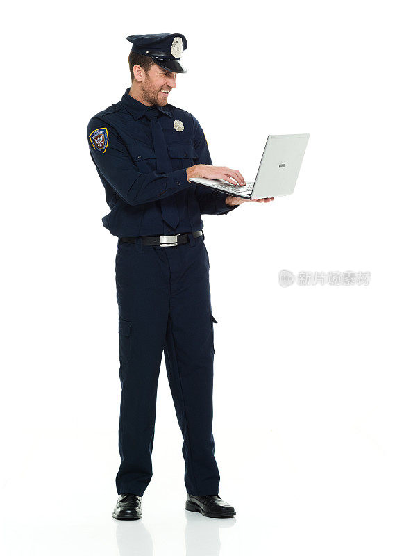 微笑的警察在笔记本电脑上工作