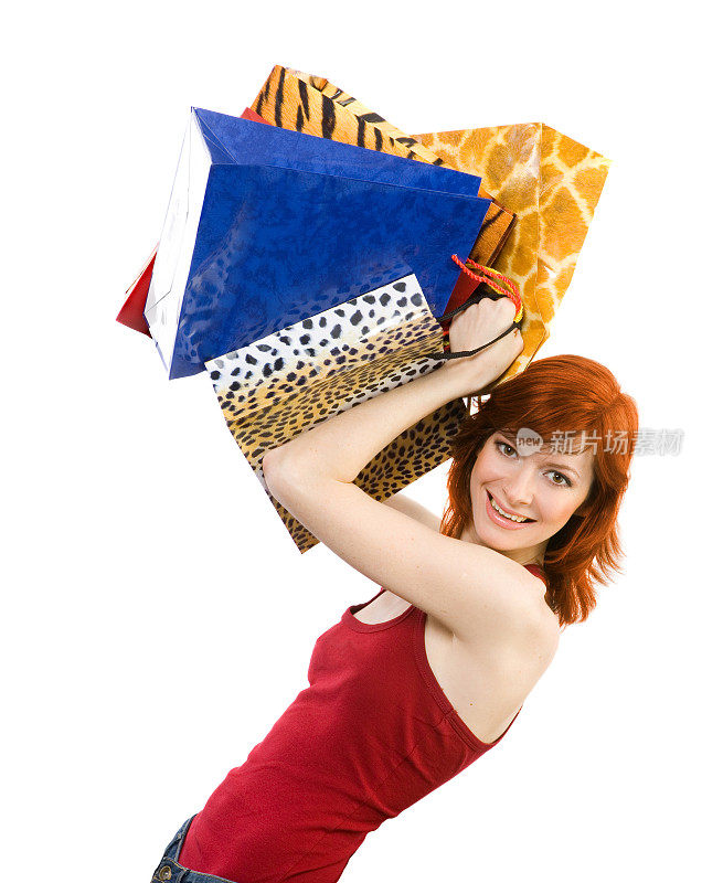 快乐的年轻女人与购物袋。