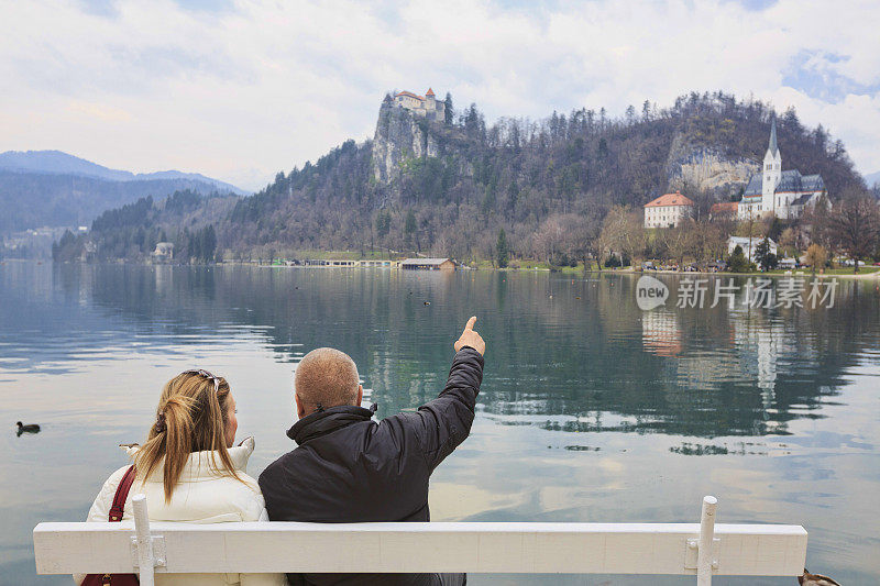 一对相爱的游客。欣赏欧洲斯洛文尼亚布莱德湖的景色。