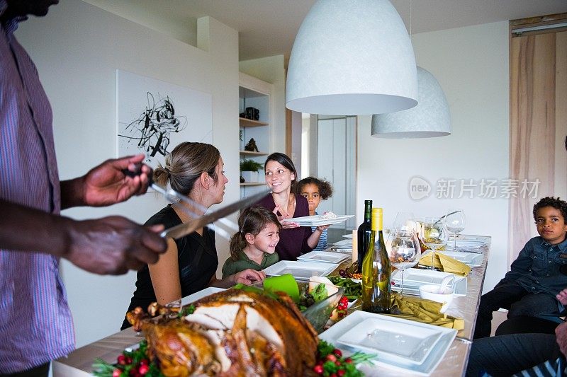 节日期间，家人和朋友在感恩节期间共进晚餐