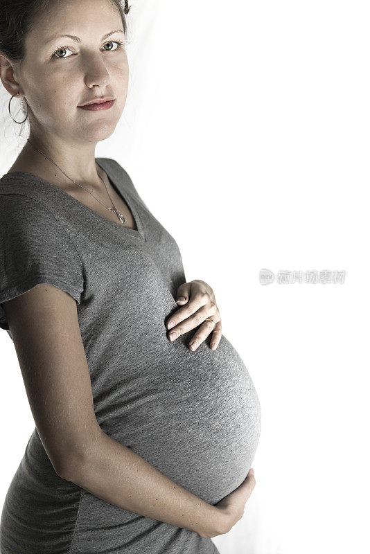 肖像怀孕的年轻女士看着相机女人的肚子