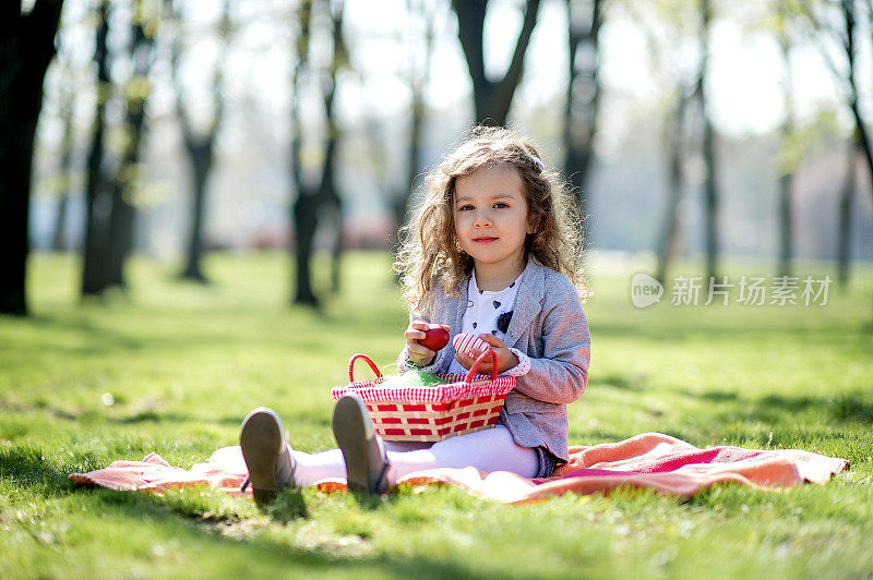 可爱的小女孩拿着一篮子复活节彩蛋