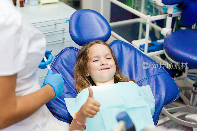 小女孩坐在牙医的椅子上。儿童牙医检查乳牙。儿童牙科治疗。预防儿童龋齿
