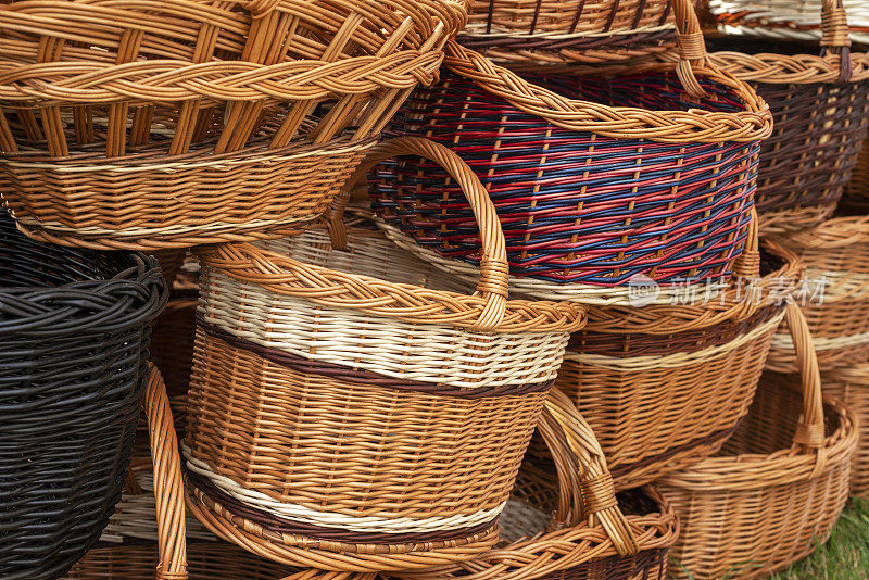 一堆不同形状的柳条篮子。街市上的手工DIY篮子