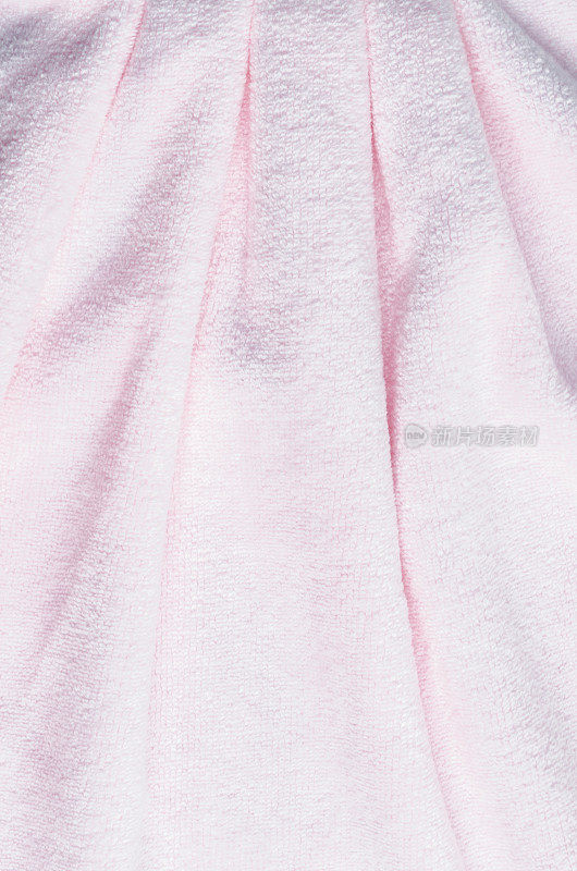 纹理的粉红色天然棉毛巾背景照片与选择性焦点。