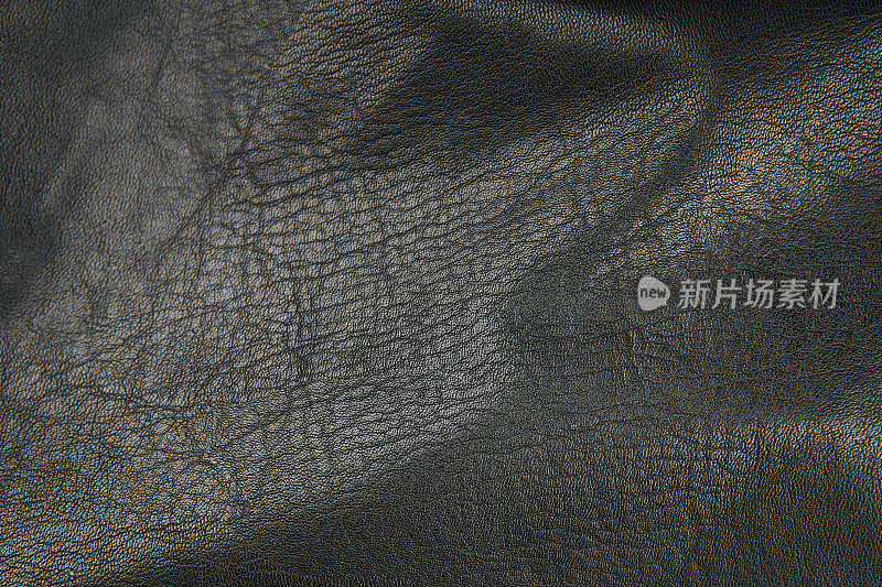 黑色皮革织物纺织材料纹理图案宏模糊背景。
