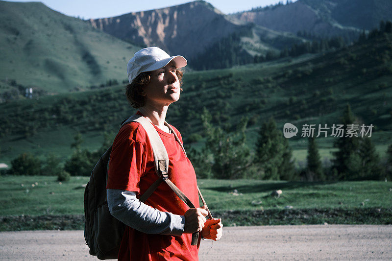 女背包客在山路上搭车