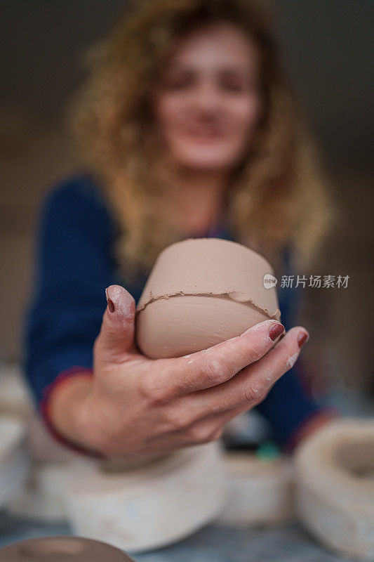 陶瓷作坊里制作陶瓷杯的妇女。