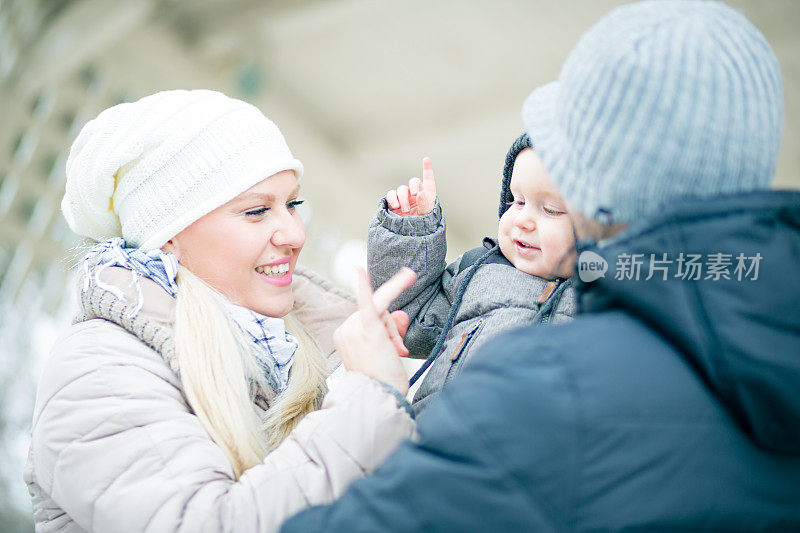 幸福的家庭户外。男婴，金发妈妈和爸爸，冬天的时候