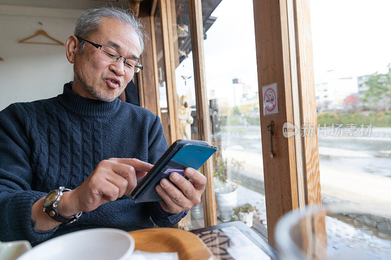 日本男子饭后使用智能手机