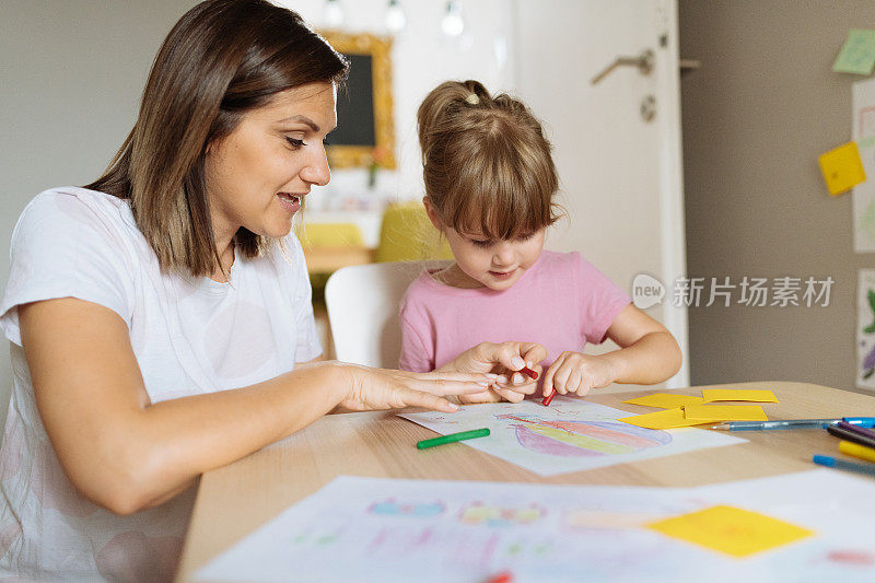 封锁期间母亲和三岁女孩在家画画