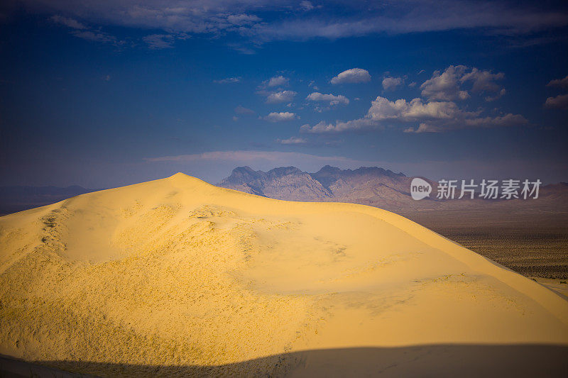 日落时分从莫哈韦沙漠沙丘上拍摄的山