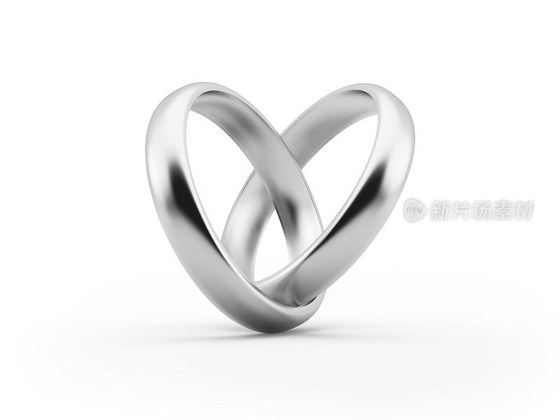 白色的黄金结婚戒指形成一个心的形状