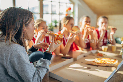 女教练和篮球队一起庆祝胜利