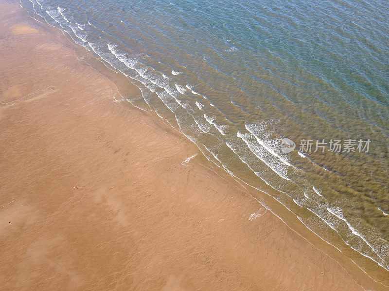 鸟瞰金色沙滩海岸线和浪花