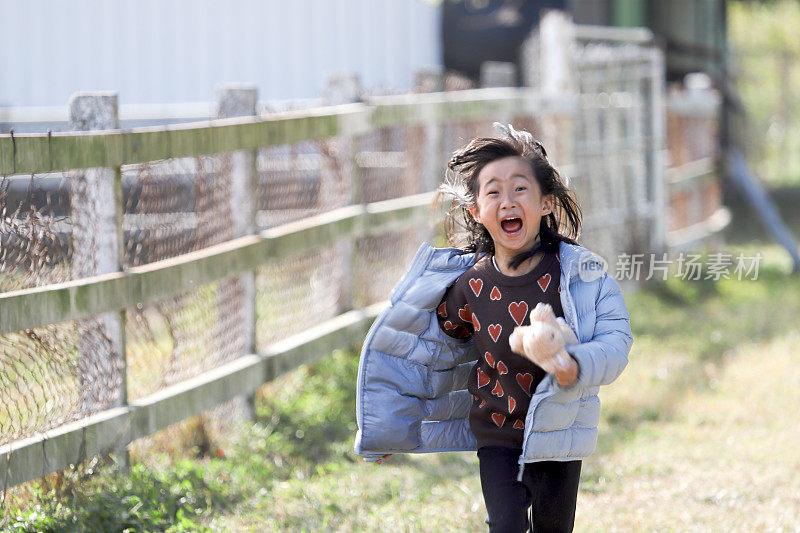 一个亚洲女孩在动物园里边跑边哭