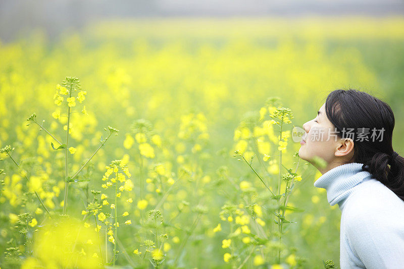 年轻的女孩闻到了花香