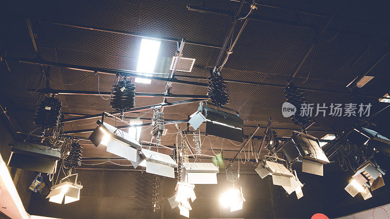 射灯在工作室天花板背景上发光。娱乐舞台上的灯光渐暗。