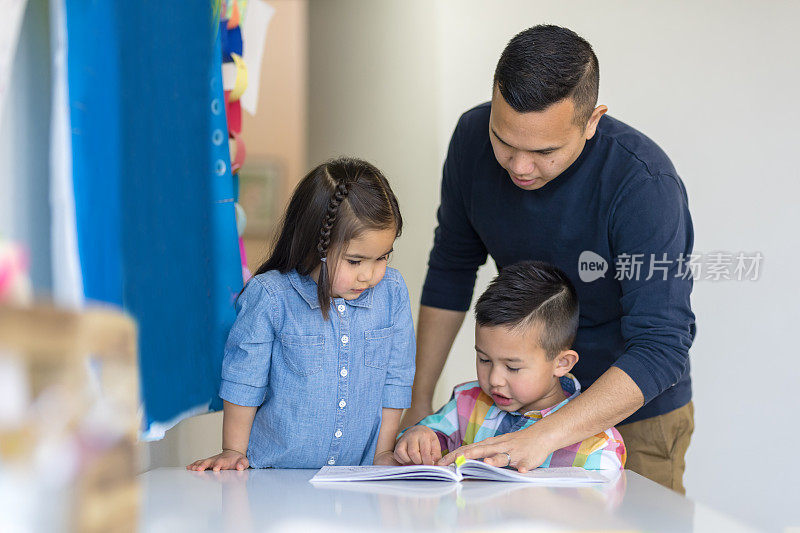 爸爸和他年幼的女儿和儿子在家上学