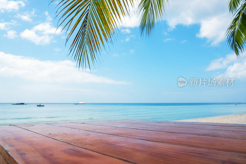 热带海滩棕榈树下的木桌