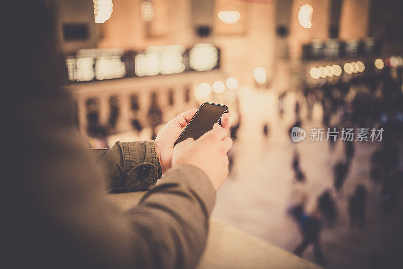 一名男子在纽约中央车站使用手机