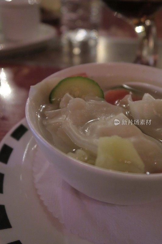 中餐馆里的鸡肉馄饨的图片，配菜勺子，中国饺子碗和东方亚洲蔬菜汤的照片