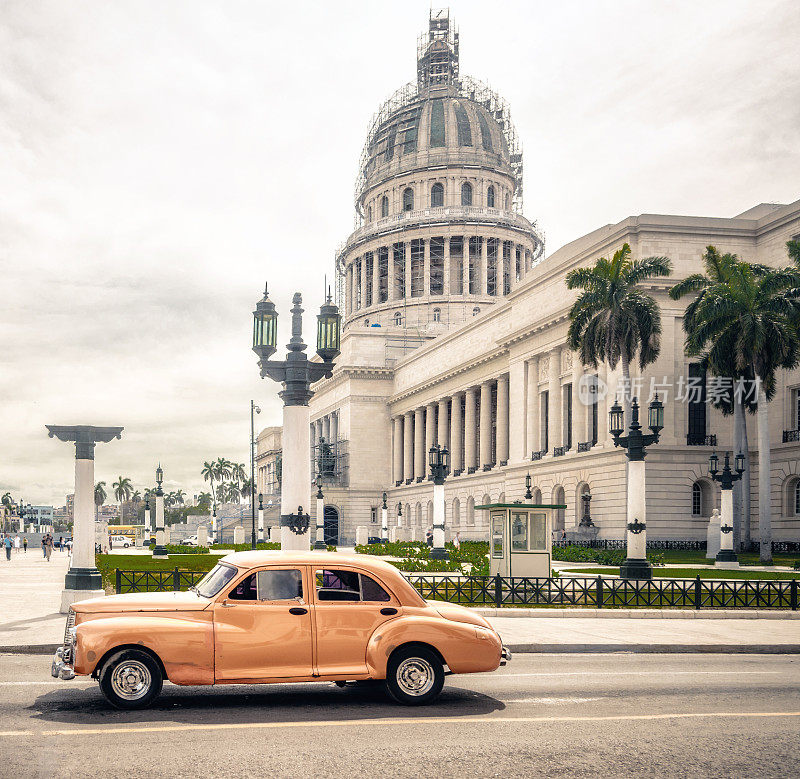 哈瓦那国会大厦前的橙色美国老爷车