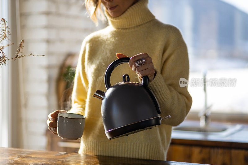 一个面目全非的年轻白人妇女在自己家里沏茶