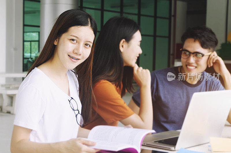 一群年轻的亚洲人在大学期间坐在讲座教育学生学院大学研究青年校园友谊。