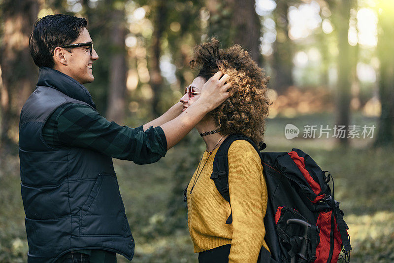 快乐的夫妇一起徒步旅行的山与背包