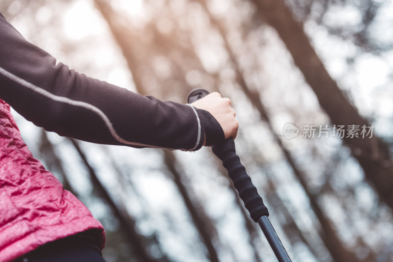 年轻的运动员女子手持登山杆