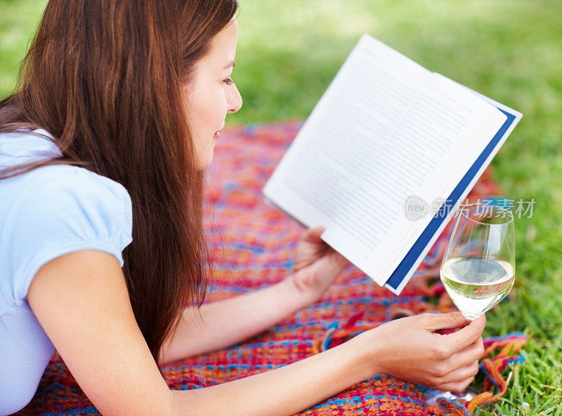 中年妇女一边喝酒一边看书