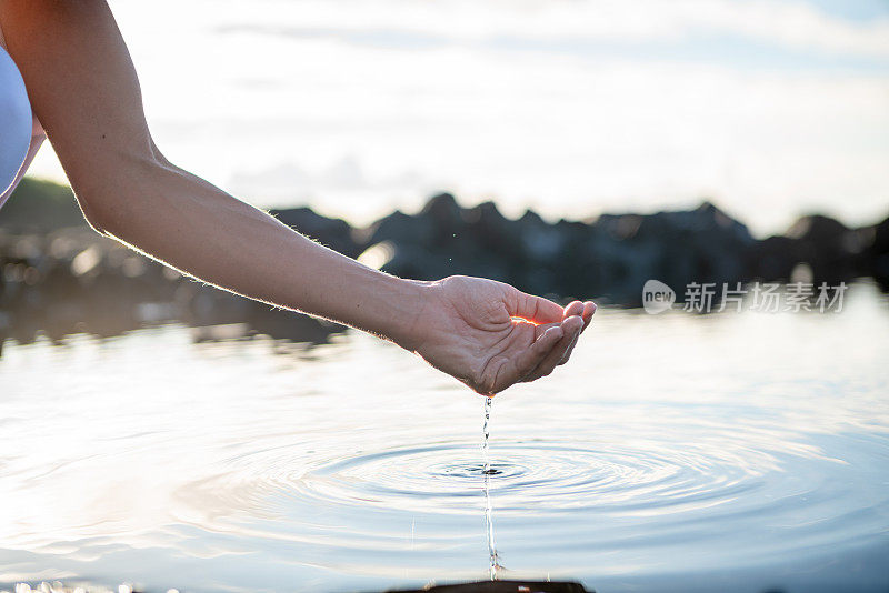 人们用手从岩石中的海池塘中捕捉淡水