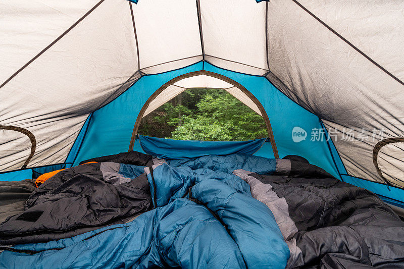 夏天的一个带睡袋的小圆顶帐篷的广角内景