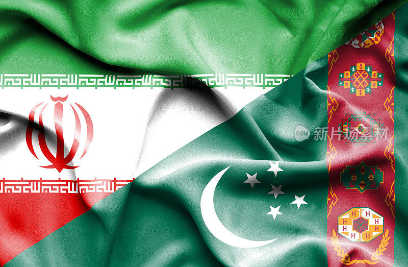 挥舞着土库曼斯坦和伊朗的旗帜