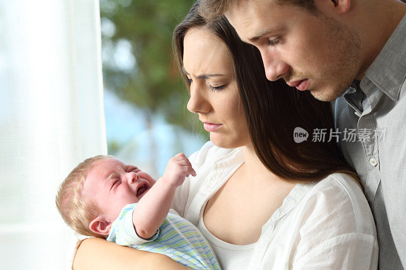 疲惫绝望的父母和哭闹的婴儿