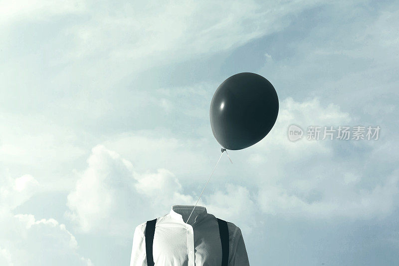 超现实的概念，大的黑色气球在风中吹动