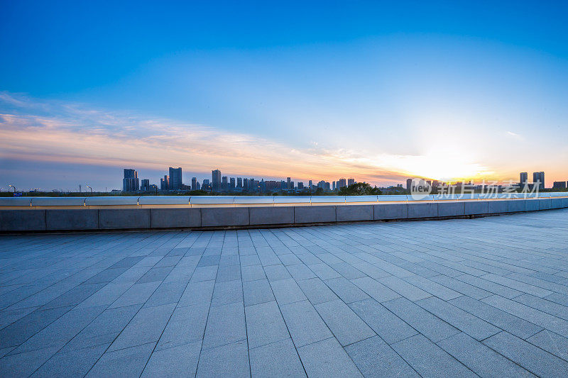 从空荡荡的砖地上看哈尔滨的城市景观和天际线