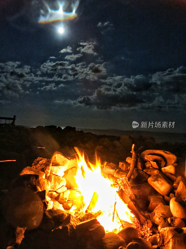 海边自制的岩石营火篝火坑，云，夜，满月